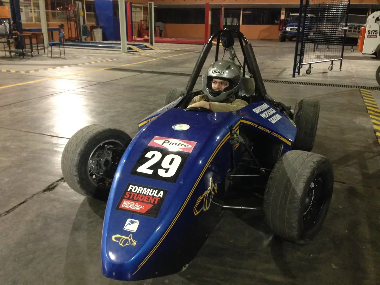 Seated in the cockpit of the blue number 29 Formula Student single-seater race car
