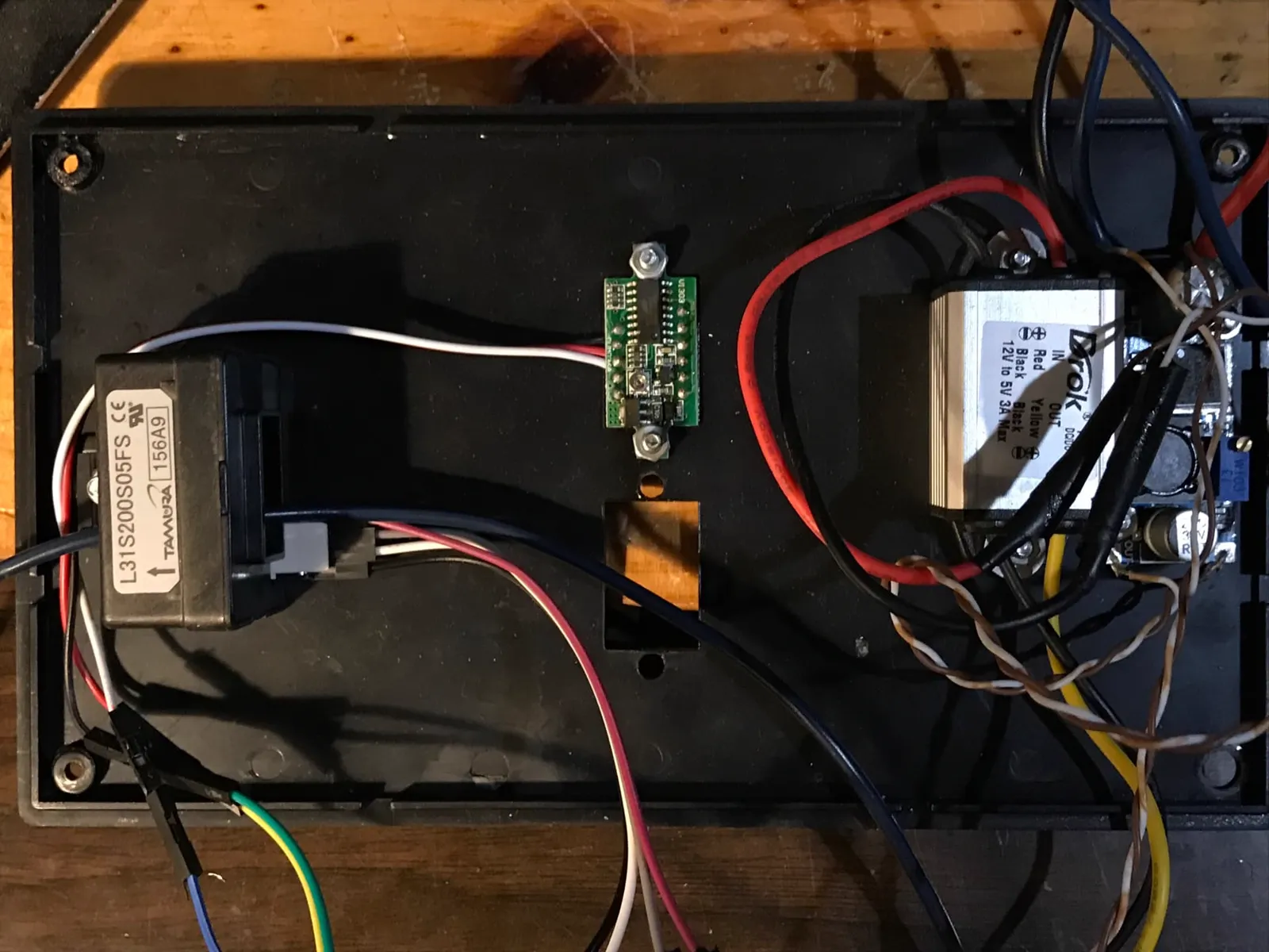 Power stage of the regenerative braking prototype with a current transducer, DC-DC converters and wiring on a black chassis